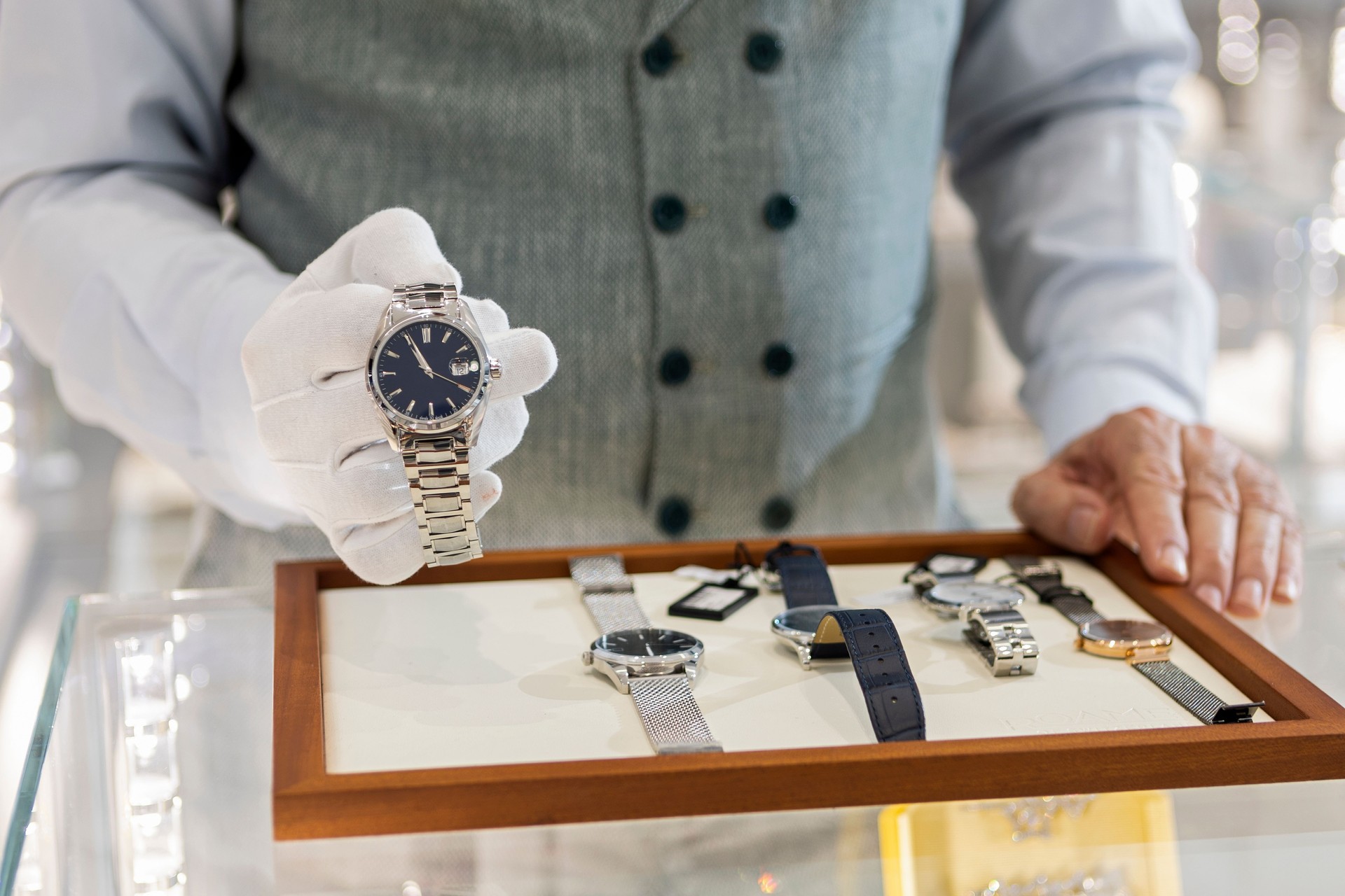 Unrecognizable person man in jewelry store selling luxury watches